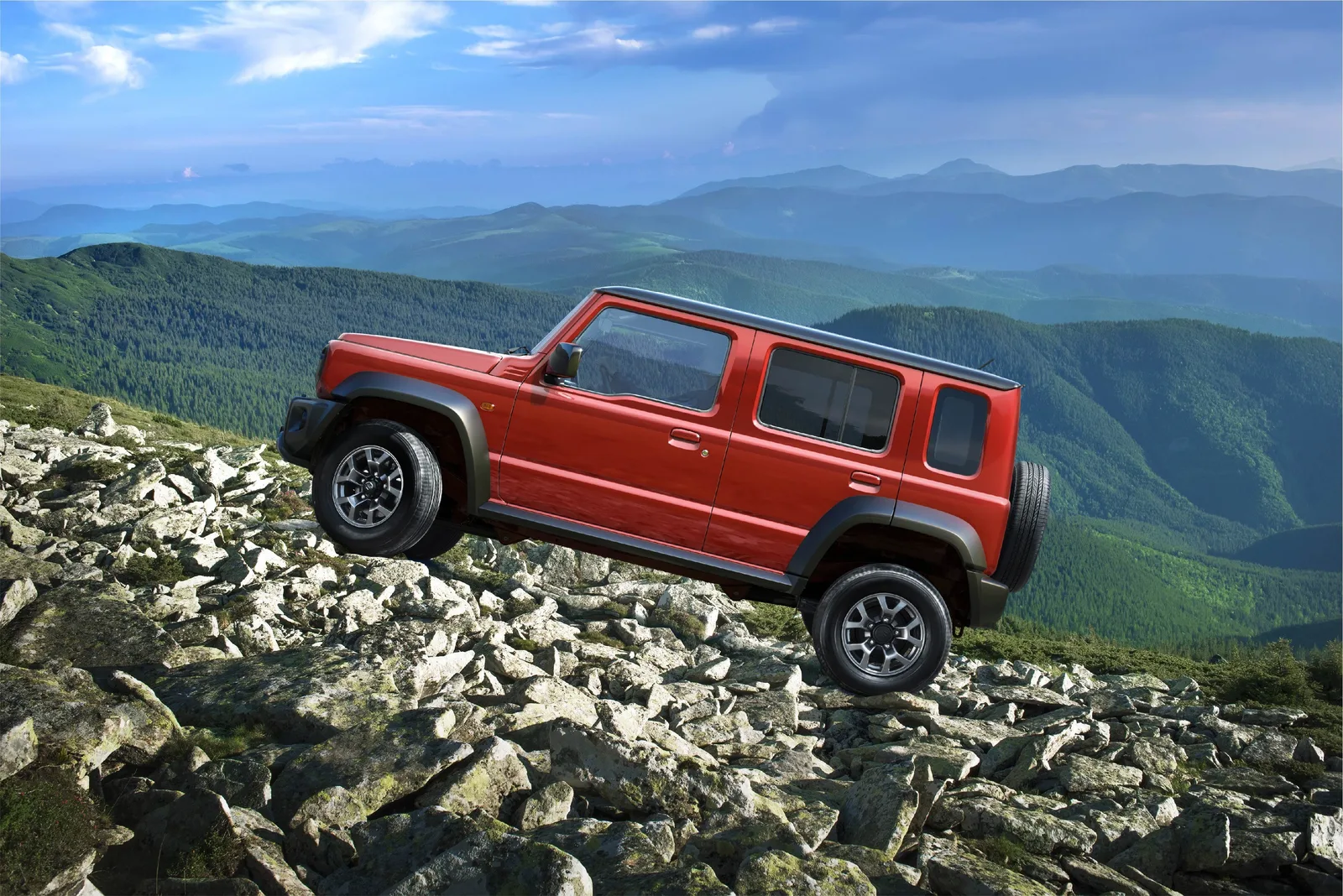 Suzuki Jimny 5-дверный 2026 — вид сбоку на камнях (5 дверей)